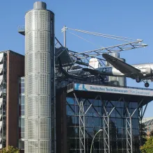 Das Deutsche Technikmuseum aus der Ferne. Man sieht den Rosinenbomber (Flugzeug) am Dach hängen.