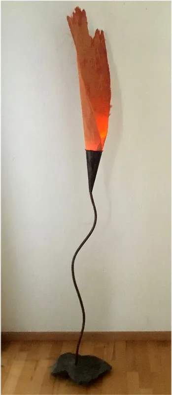 Flame- Naturmaterialien (Stein; Kupfer; gefärbte Palmfaser) sind geschickt miteinander verbunden und erzeugen durch eine Feuereffekt-Led-Lampe eine menschgroße Flamme.