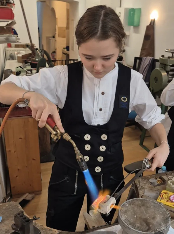Goldschmiedin beim Einschmelzen von Gold