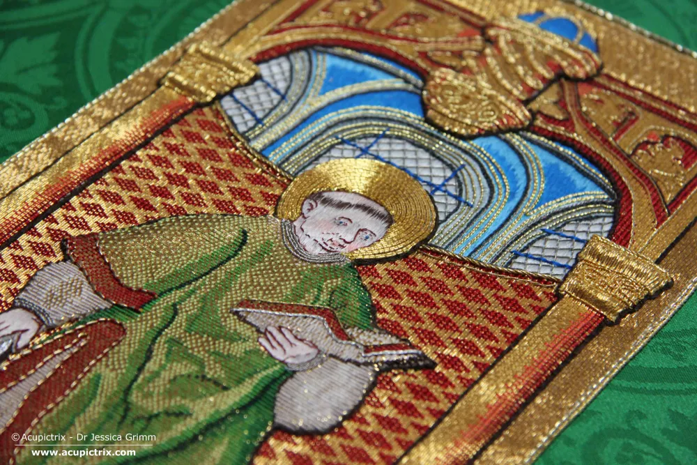 St Laurence stitched in gold and silk